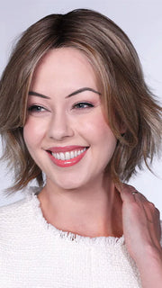 Model is wearing FERRARI By BELLETRESS in color SUNKISSED ALMOND R | A blend of Medium and Light Brown with Light Gold Blonde Highlights and a hint of Cooler Blonde, rooted with Medium and Light Brown