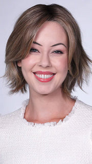 Model is wearing FERRARI By BELLETRESS in color SUNKISSED ALMOND R | A blend of Medium and Light Brown with Light Gold Blonde Highlights and a hint of Cooler Blonde, rooted with Medium and Light Brown