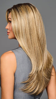 Model is wearing STAY OUT LATE in color GF12-22SS SS CAPPUCCINO | A radiant blend of warm blonde tones with sunlit highlights and soft dimension
