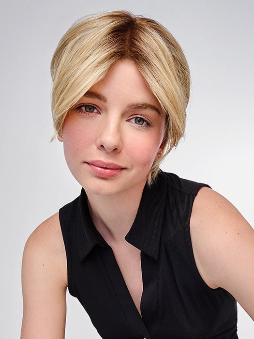 Model is wearing HD 6IN AU NATUREL TOPPER in color SS14/88 ROOTED GOLDEN WHEAT | Dark Blonde Evenly Blended with Pale Blonde Highlights and Dark Roots
