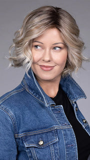 Model is wearing HOUSTON in color MILKSHAKE BLONDE R | A mixture of Light Sandy Brown, Highlighted with Light Ash Blonde with a Hint of Light Platinum Blonde with a Medium Root Color
