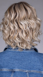 Model is wearing HOUSTON in color MILKSHAKE BLONDE R | A mixture of Light Sandy Brown, Highlighted with Light Ash Blonde with a Hint of Light Platinum Blonde with a Medium Root Color