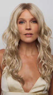 Model is wearing HANA by NORIKO in color Light Ash Blond R | Cream Ash Blonde with ash brown and white-grey roots that blend into a variety of ash blonde tones, including ash pearl blonde, creamy ivory, and pale cream