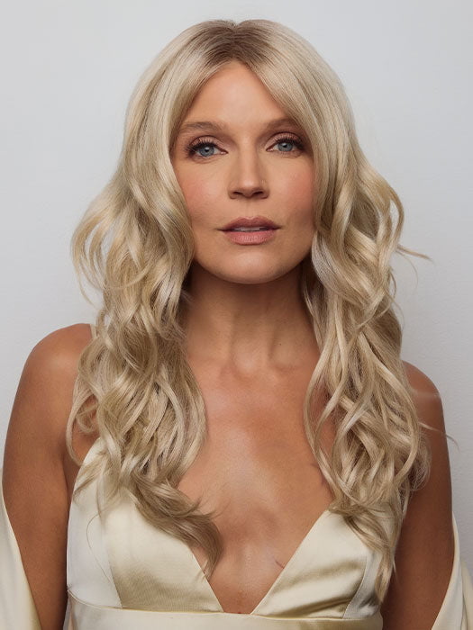 Model is wearing HANA by NORIKO in color Light Ash Blond R | Cream Ash Blonde with ash brown and white-grey roots that blend into a variety of ash blonde tones, including ash pearl blonde, creamy ivory, and pale cream