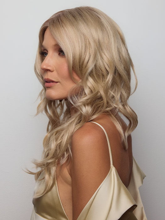 Model is wearing HANA by NORIKO in color Light Ash Blond R | Cream Ash Blonde with ash brown and white-grey roots that blend into a variety of ash blonde tones, including ash pearl blonde, creamy ivory, and pale cream
