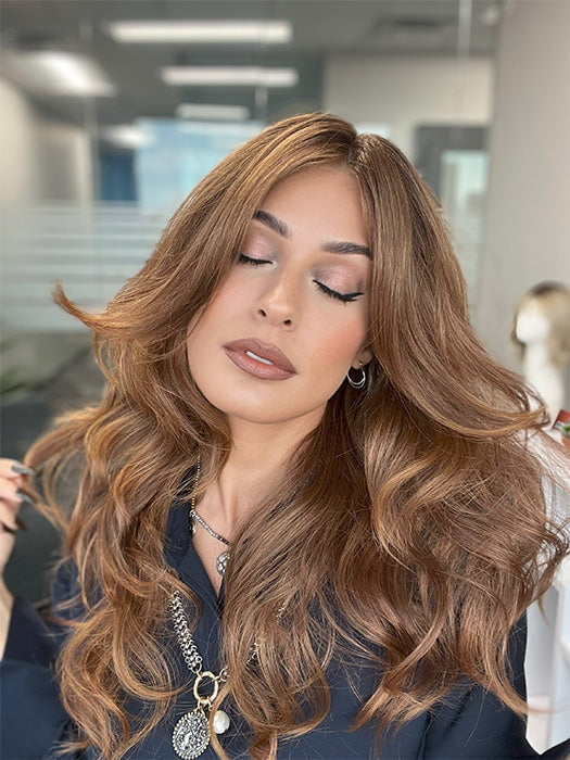 Model is wearing HANA by NORIKO in color Venetian Red R | A beautiful red shade that mixes pale copper, soft mahogany, and warm burnt-toffee cherry tones. The rich chestnut roots add dimension and depth. 