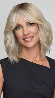 Model is wearing HOLLIE PETITE by JON RENAU in color CATALINA BLONDE 101/88/27S8 | Pale blonde with Pure White Natural Violet halo highlights, shaded medium brown