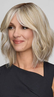 Model is wearing HOLLIE PETITE by JON RENAU in color CATALINA BLONDE 101/88/27S8 | Pale blonde with Pure White Natural Violet halo highlights, shaded medium brown