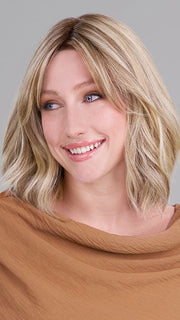 Model is wearing HOLLIE PETITE by JON RENAU in color 12FS12 MALIBU BLONDE | Light Gold Brown, Light Natural Gold Blonde, Pale Natural Gold-Blonde Blend, Shaded with Light Gold Brown