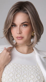 Model is wearing MIRA by AMORE in color TRES CHOCOLATE R | Carefully placed White, Medium, and Dark Chocolate tones completed with a Dark Brown Root. This color is perfect for both Blond and Brown enthusiasts.   