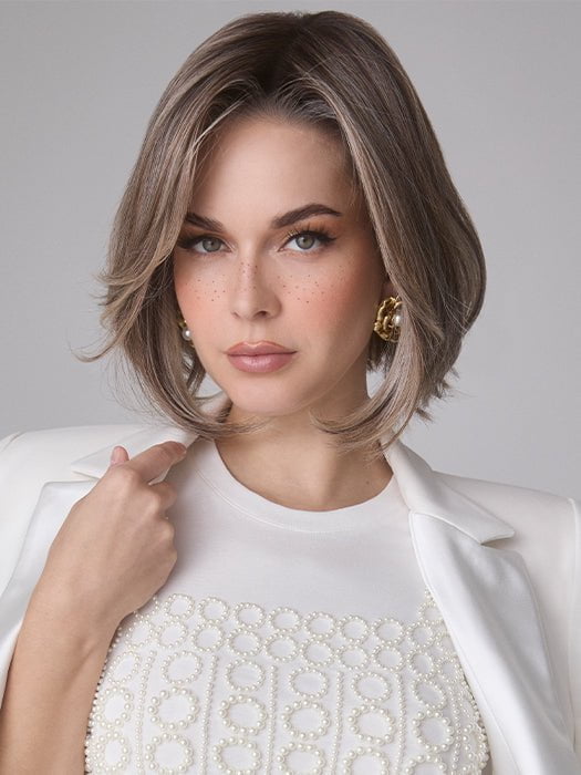 Model is wearing MIRA by AMORE in color TRES CHOCOLATE R | Carefully placed White, Medium, and Dark Chocolate tones completed with a Dark Brown Root. This color is perfect for both Blond and Brown enthusiasts.   