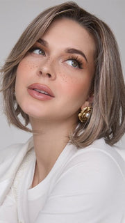 Model is wearing MIRA by AMORE in color TRES CHOCOLATE R | Carefully placed White, Medium, and Dark Chocolate tones completed with a Dark Brown Root. This color is perfect for both Blond and Brown enthusiasts.   