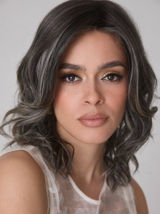 Model is wearing ROHAN by AMORE in color TRUFFLE RIBBON R | Off-Black base with Warm Medium Brown and Silver highlights. The Dark Brown Root creates a naturally dimensional appearance