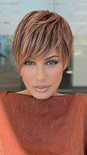 Model is wearing JETT by ESTETICA in color CINDER HEAT | Reddish brown base blended with smoked copper with soft amber highlights and chestnut brown roots.
