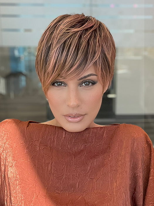 Model is wearing JETT by ESTETICA in color CINDER HEAT | Reddish brown base blended with smoked copper with soft amber highlights and chestnut brown roots.