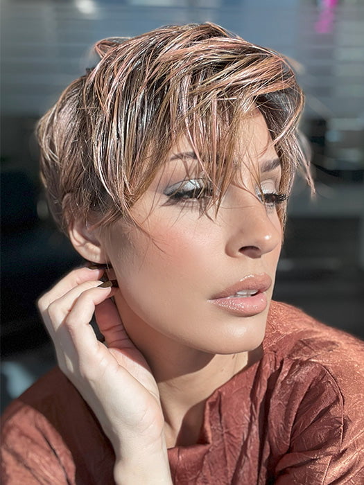 Model is wearing JETT by ESTETICA in color CINDER HEAT | Reddish brown base blended with smoked copper with soft amber highlights and chestnut brown roots.
