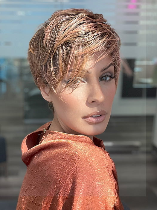 Model is wearing JETT by ESTETICA in color CINDER HEAT | Reddish brown base blended with smoked copper with soft amber highlights and chestnut brown roots.