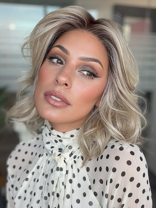 Model is wearing LORYN in color SEA SEA SALT BLOND R | A perfect mixture of cool, icy-blond and warm-dark blond. The rich brown root tone enhances the modern appearance