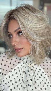 Model is wearing LORYN in color SEA SEA SALT BLOND R | A perfect mixture of cool, icy-blond and warm-dark blond. The rich brown root tone enhances the modern appearance