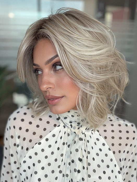 Model is wearing LORYN in color SEA SEA SALT BLOND R | A perfect mixture of cool, icy-blond and warm-dark blond. The rich brown root tone enhances the modern appearance
