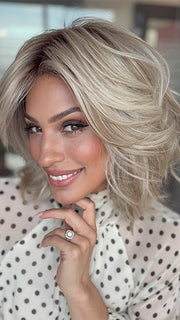 Model is wearing LORYN in color SEA SEA SALT BLOND R | A perfect mixture of cool, icy-blond and warm-dark blond. The rich brown root tone enhances the modern appearance