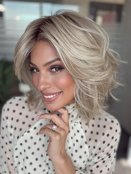 Model is wearing LORYN in color SEA SEA SALT BLOND R | A perfect mixture of cool, icy-blond and warm-dark blond. The rich brown root tone enhances the modern appearance