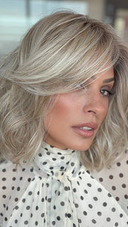 Model is wearing LORYN in color SEA SEA SALT BLOND R | A perfect mixture of cool, icy-blond and warm-dark blond. The rich brown root tone enhances the modern appearance