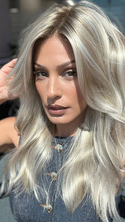 Model is wearing OLIVIA by JON RENAU in color FS17/101S18 PALM SPRINGS BLONDE | Light Ash Blonde with Pure White Natural Violet Bold Highlights, Shaded with Dark Natural Ash Blonde