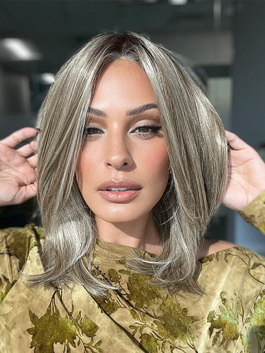 Roxie is wearing OWN THE ROOM LUXURY by GABOR in color GF12-22SS CAPPUCCINO | Light Golden Brown Evenly Blended with Cool Platinum Blonde Highlights with Dark Roots
