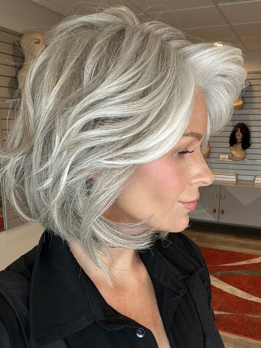 Madeline is wearing WAVES AND RAVES by RAQUEL WELCH in RL51/61 ICED GRANITA | Lightest Grey Progresses to a Deep Grey at the Nape