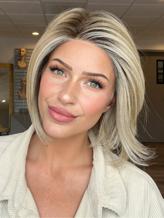 Madeline is wearing STRAIGHT UP WITH A TWIST ELITE by RAQUEL WELCH in RL19/23SS SHADED BISCUIT | Light Ash Blonde Evenly Blended with Cool Platinum Blonde with Dark Roots