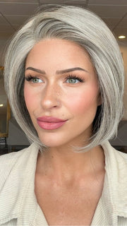 Madeline is wearing STRAIGHT UP WITH A TWIST ELITE by RAQUEL WELCH in RL119 SILVER AND SMOKE | Light Brown with 80% Gray in Front Gradually into 50% Gray Towards the Nape