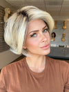 Model is wearing IGNITE by JON RENAU in color 101/88/27S8 CATALINA BLONDE | Pale blonde with Pure White Natural Violet halo highlights, shaded medium brown