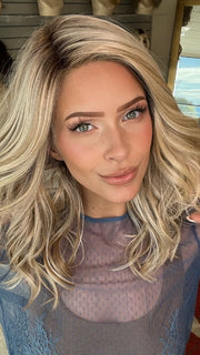 Madeline wearing LAGUNA BEACH by BELLETRESS in MILKSHAKE BLONDE R | A mixture of Light Sandy Brown, Highlighted with Light Ash Blonde with a Hint of Light Platinum Blonde with a Medium Root Color