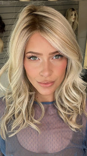 Madeline wearing LAGUNA BEACH by BELETRESS in CRUSHED ALMOND BLONDE R | A soft Neutral Light Blonde with a Light and Medium Blended Root Color.
