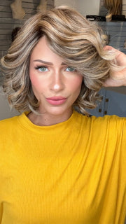 Madeline wearing HOUSTON by BELLETRESS in BROWN SUGAR BLONDE-R | A warm, dimensional blend of medium brown and golden blonde highlights with natural-looking darker roots for depth and a sun-kissed finish.