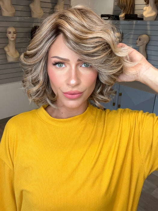 Madeline wearing HOUSTON by BELLETRESS in BROWN SUGAR BLONDE-R | A warm, dimensional blend of medium brown and golden blonde highlights with natural-looking darker roots for depth and a sun-kissed finish.