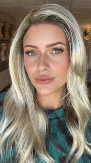 Madeline is wearing OLIVIA by JON RENAU in color FS17/101S18 PALM SPRINGS BLONDE | Light Ash Blonde with Pure White Natural Violet Bold Highlights, Shaded with Dark Natural Ash Blonde