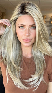 Madeline is wearing SCENE STEALER by RAQUEL WELCH in RL19/23SS SHADED BISCUIT | Light Ash Blonde Evenly Blended with Cool Platimun Blonde and Dark Roots