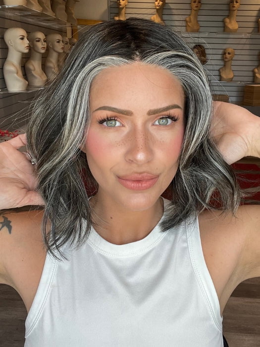 Madeline is wearing MIRA by AMORE in TRUFFLE RIBBON R | Off-Black base with Warm Medium Brown and Silver highlights. The Dark Brown Root creates a naturally dimensional appearance