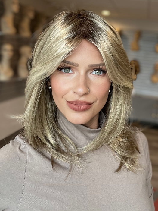 Madeline is wearing SANDRA by JON RENAU in 22F16S8 VENICE BLONDE | Light Ash Blonde and Light Natural Blonde Blend, Shaded with Medium Brown