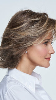 A mid-length shag wig with multiple layers that create a stylish piecey texture th