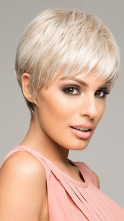This short wig has a wispy bang, textured layering on top with length at the crown and layered ends