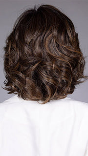 Model is wearing TWAIN in color FRENCH ROAST BROWN R | A deep, luxurious brunette featuring a dark brown base with warm bronze and subtle red undertones. Softly rooted for natural depth and dimension.