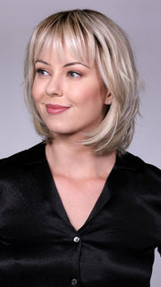 Model is wearing TRIBECA By BELLETRESS in CRUSHED-ALMOND-BLONDE-R | A Soft Neutral Light Blonde with a Light and Medium Blended Root Color