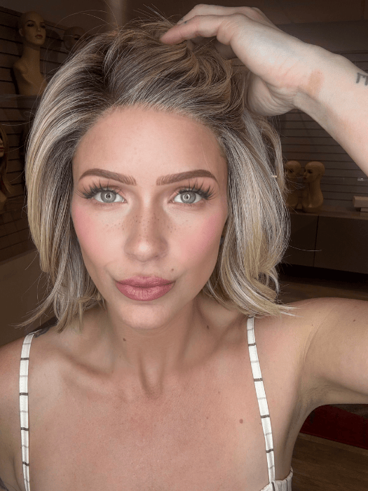 MADELINE is wearing Alicante by Belle Tress in color RAW SUGAR BLONDE | A Neutral Light Blonde, Honey Blonde, Pale Gold Blonde, with a base of Light Brown Low Lights featuring a Medium Root Color