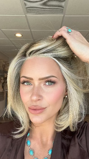 Madeline is wearing UPSTAGE by RAQUEL WELCH WIGS in color RL19/23SS SHADED BISCUIT | Light Ash Blonde Evenly Blended with Cool Platinum Blonde with Dark Roots 