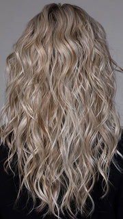 Model is wearing WESTWOOD in BUTTER BEER BLONDE | Dark Brown Base and Root that transitions smoothly into a buttery blonde, infused with creamy honey and toffee tones