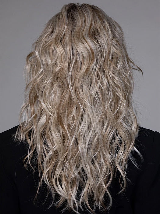 Model is wearing WESTWOOD in BUTTER BEER BLONDE | Dark Brown Base and Root that transitions smoothly into a buttery blonde, infused with creamy honey and toffee tones