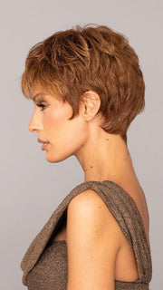 Roxie is wearing the WINNER by RAQUEL WELCH in color R3025S+ GLAZED CINNAMON | Medium Auburn with Ginger Blonde Highlights on Top